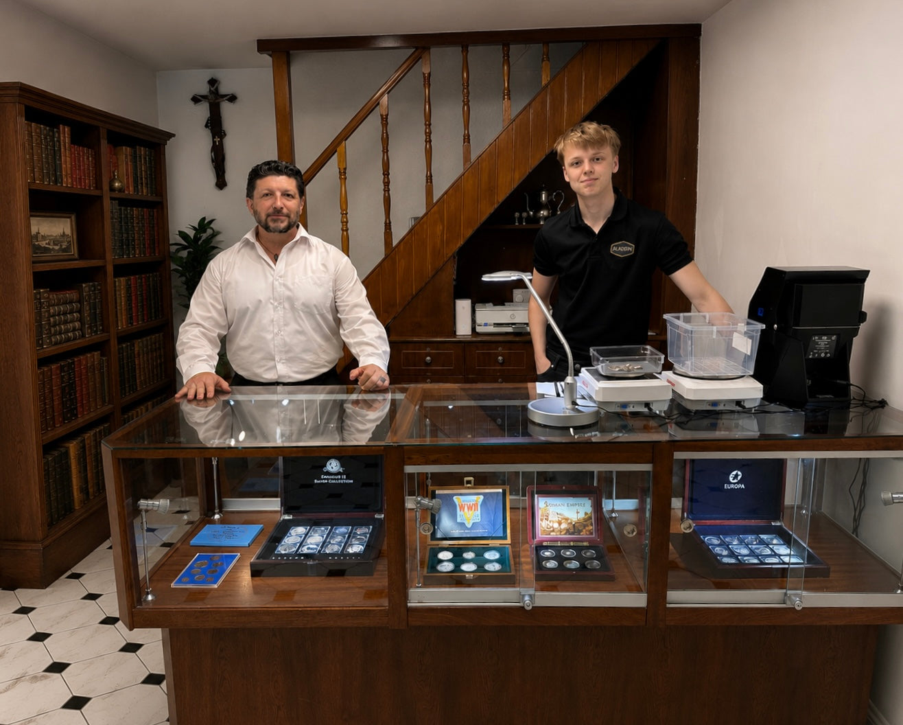 The Aladdin Cork team behind the counter with collectible coins on display